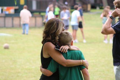 Mother and son hugging at summer camp