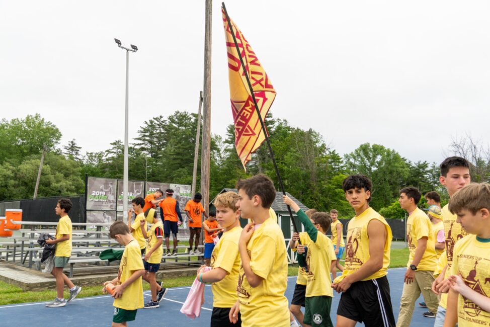 yellow team walking with their flag