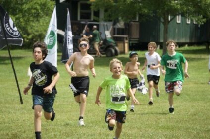 campers running on the field to celebrate the kick off of the stockbridge series