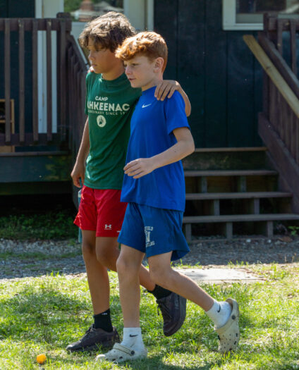 two campers walking together happily